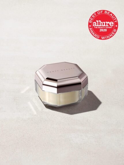 Closed container of Pro Filt'r Instant Retouch Setting Powder in shade butter on a concrete background. Allure best of beauty award winner 2020 badge on the top right.