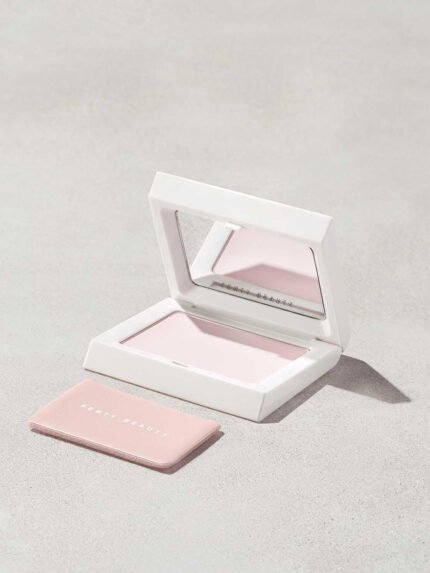 Open compact of the Invisimatte Setting Powder and sponge on a light background.