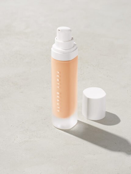 open bottle of Fenty Beauty Pro Filt'r Soft Matte Longwear Foundation with pump dispenser in shade #120 on concrete background