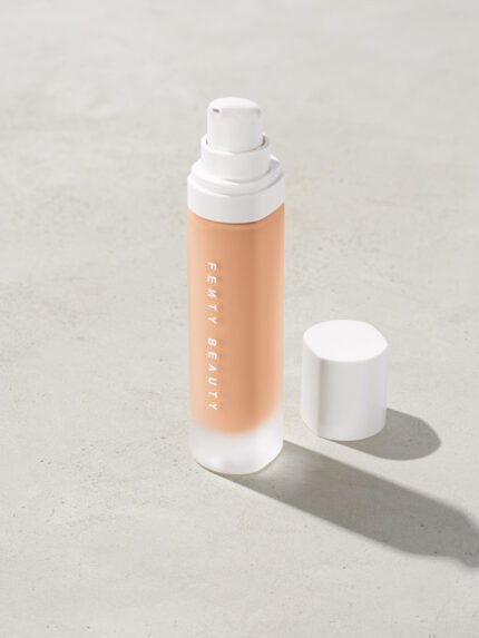 open bottle of Fenty Beauty Pro Filt'r Soft Matte Longwear Foundation with pump dispenser in shade #170 on concrete background