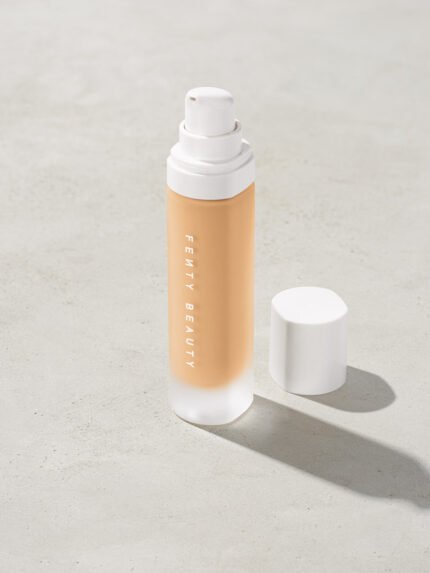 open bottle of Fenty Beauty Pro Filt'r Soft Matte Longwear Foundation with pump dispenser in shade #190 on concrete background