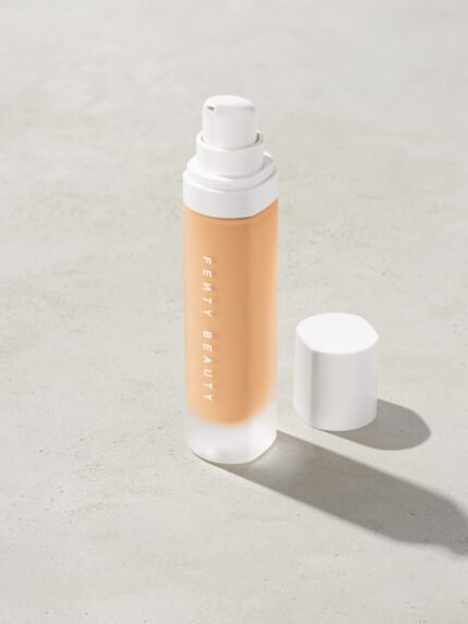 open bottle of Fenty Beauty Pro Filt'r Soft Matte Longwear Foundation with pump dispenser in shade #200 on concrete background