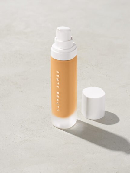 open bottle of Fenty Beauty Pro Filt'r Soft Matte Longwear Foundation with pump dispenser in shade #250 on concrete background