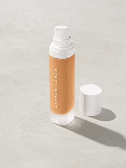open bottle of Fenty Beauty Pro Filt'r Soft Matte Longwear Foundation with pump dispenser in shade #280 on concrete background