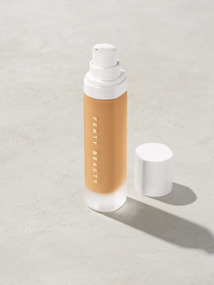 open bottle of Fenty Beauty Pro Filt'r Soft Matte Longwear Foundation with pump dispenser in shade #290 on concrete background