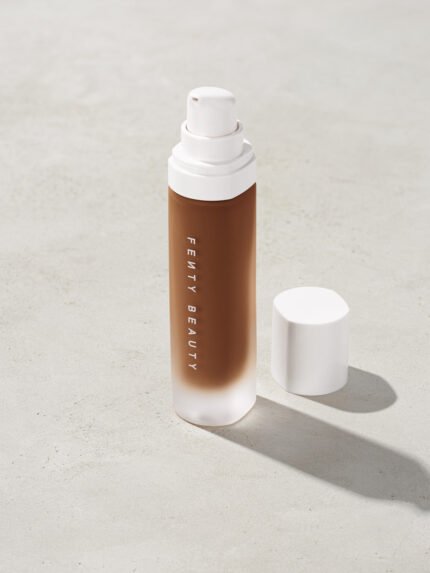 open bottle of Fenty Beauty Pro Filt'r Soft Matte Longwear Foundation with pump dispenser in shade 480 on concrete background