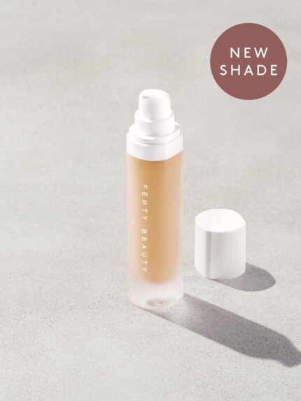Open bottle of a new shade of Fenty Beauty Pro Filt'r Soft Matte Longwear Foundation with pump dispenser in shade #265 on concrete background