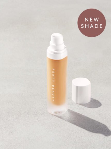 Open bottle of a new shade of Fenty Beauty Pro Filt'r Soft Matte Longwear Foundation with pump dispenser in shade #315 on concrete background