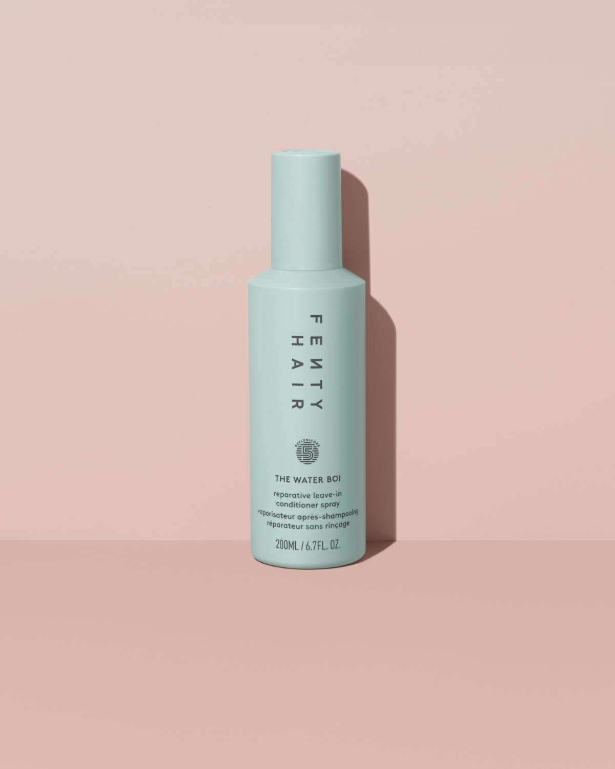 FH25_T2PRODUCT_ECOMM_WATER-BOI_1200X1500_72DPI_1 The Water Boi Reparative Leave-In Conditioner Spray on a peach background.