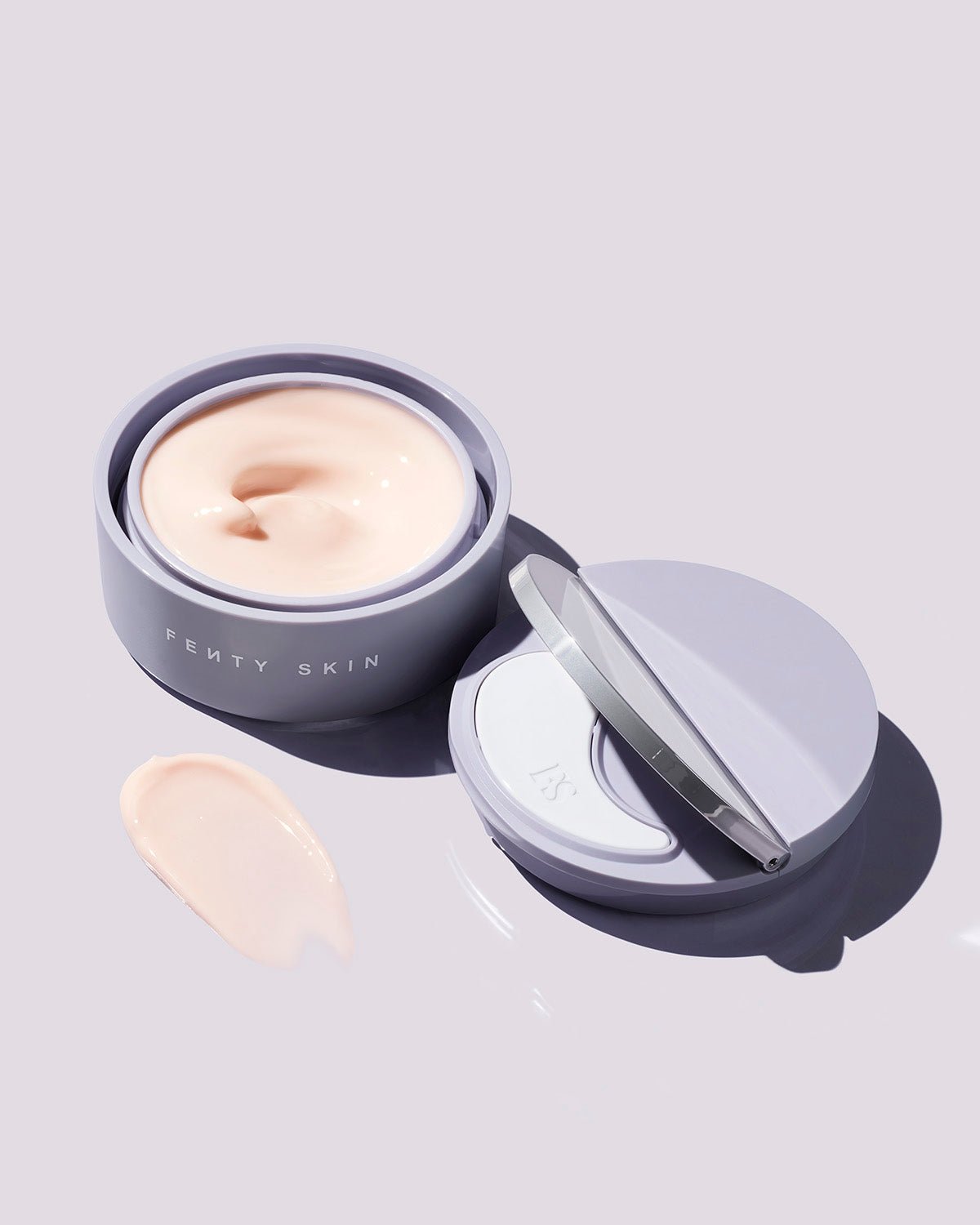 FS_FA20_T2PRODUCT_INSTANTRESETOVERNIGHTGELCREME_SHOT08_1200x1500_136063f9-e296-4471-b8c0-d685d10cb6ac Instant Reset Gel container opened next to its lid, showing the applicator, on a lilac background.