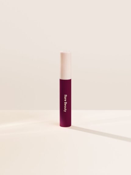 Strengthen| Shade Strengthen, in a dark blue red, of the Lip Souffle Matte Lip Cream by Rare Beauty.